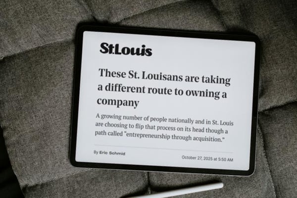 Tablet on a cushioned surface displaying an article from St. Louis magazine about locals taking a different route to owning a company through entrepreneurship through acquisition.