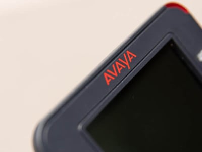 Close-up of an Avaya J169 desk phone with the logo in focus.