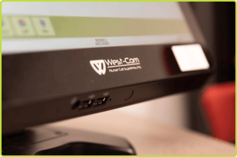 Close-up of a West-Com NOVUS Connect nurse console with USB ports and illuminated controls