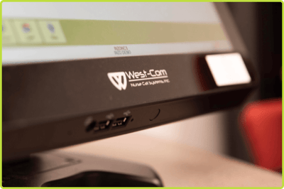 Close-up of a West-Com NOVUS Connect nurse console with USB ports and illuminated controls